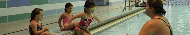 Child jumping in the pool for a lesson